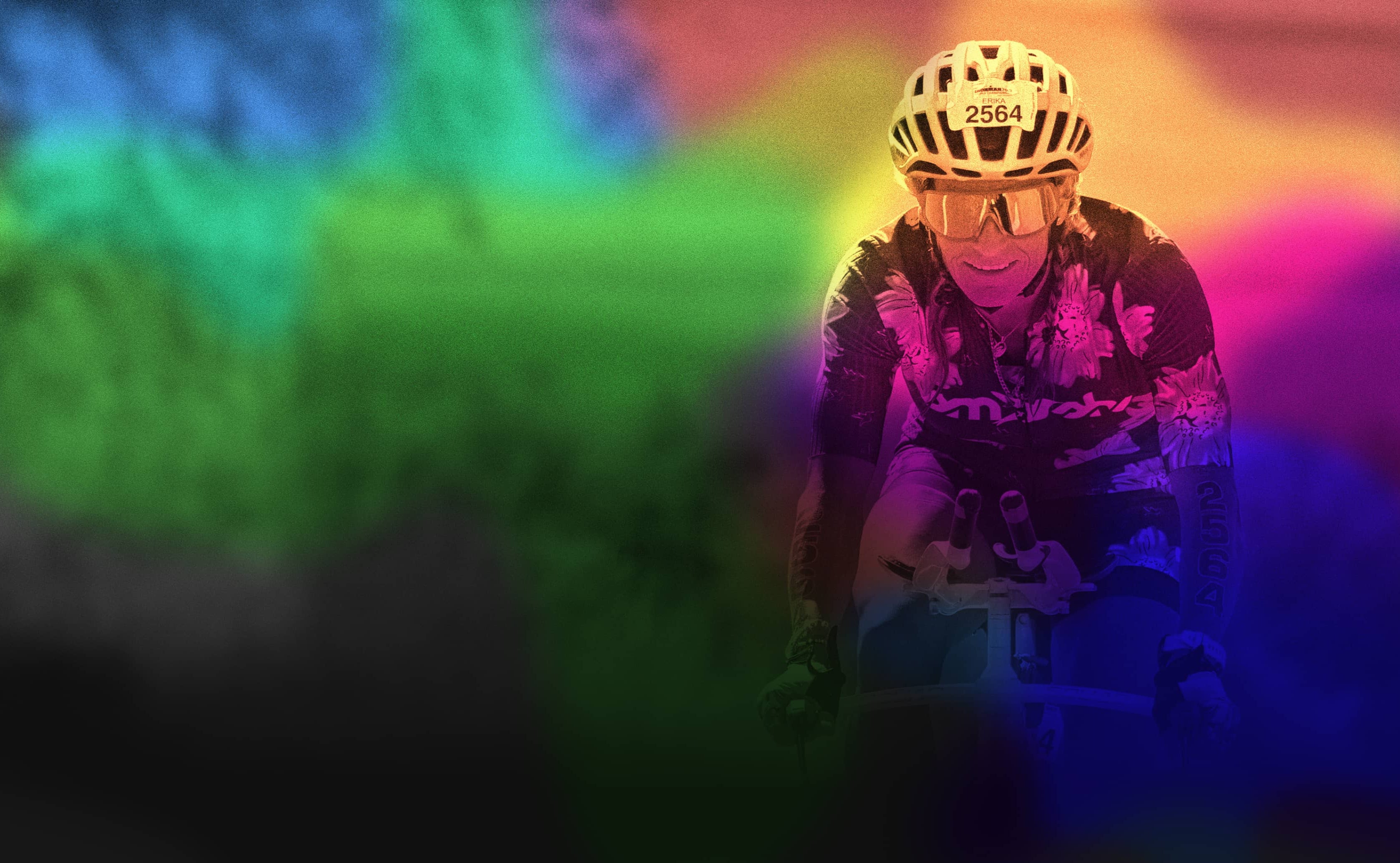 Person wearing a helmet and colorful outfit with a rainbow gradient background