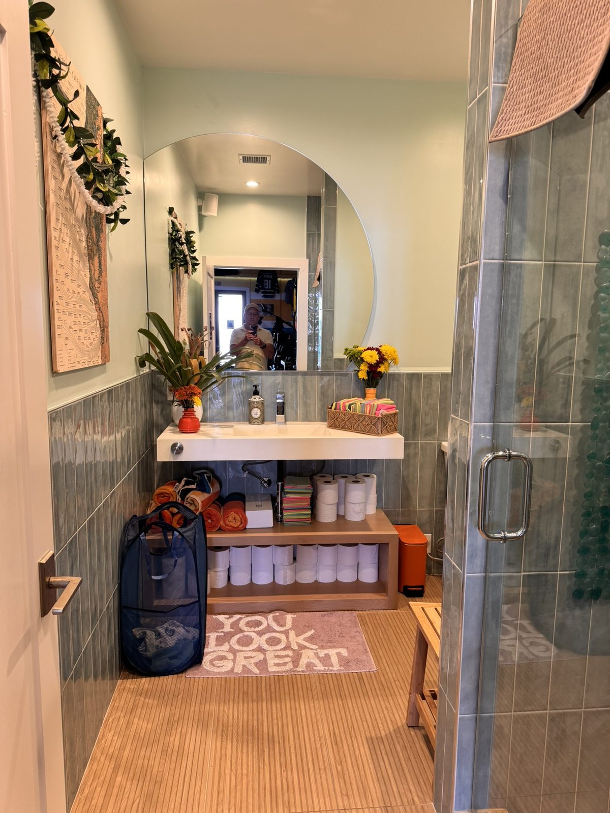 The bathroom vanity at Lilley Fitness, with folded towels and a mat that says You look great.