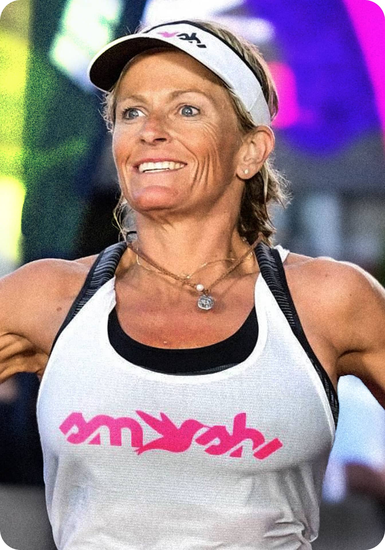 Coach Erika Lilley smiling in a white training top.