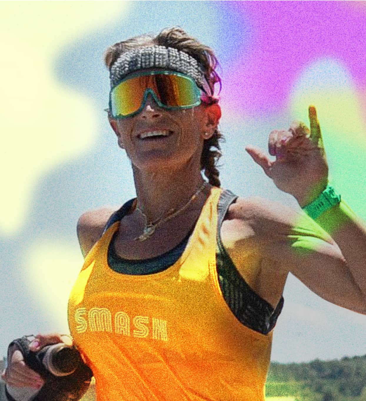 Erika Lilley outdoors in a yellow training tank and sunglasses, smiling.